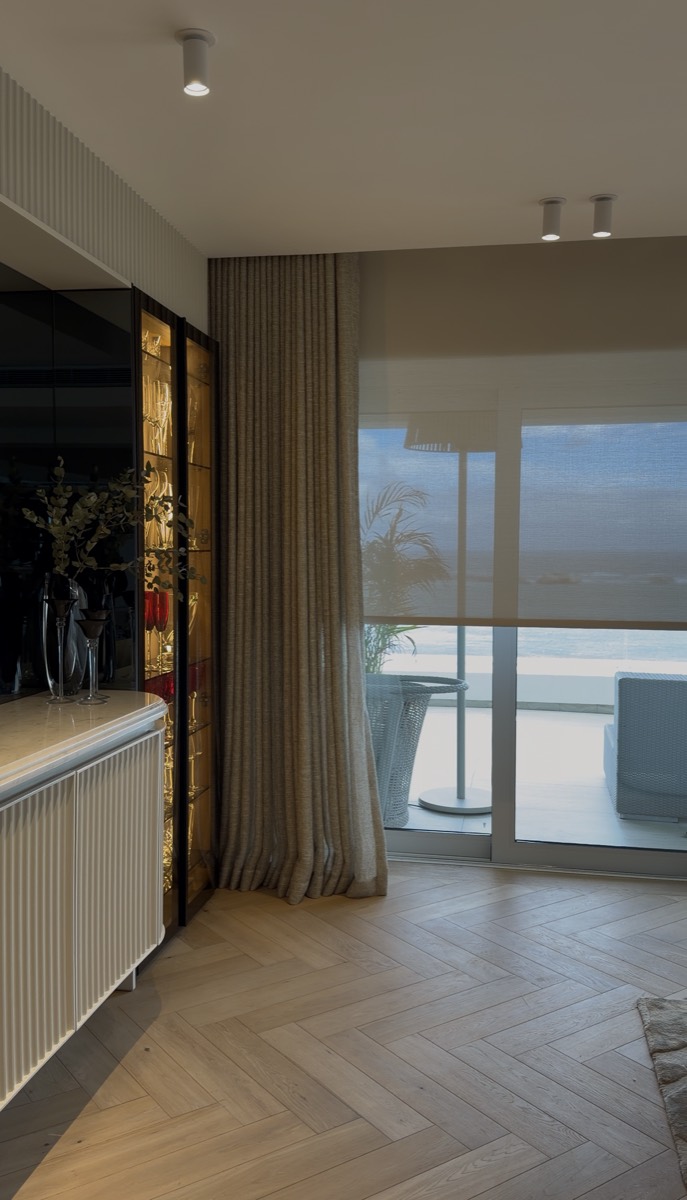 Floor-to-ceiling curtains with sheer blind and ocean view