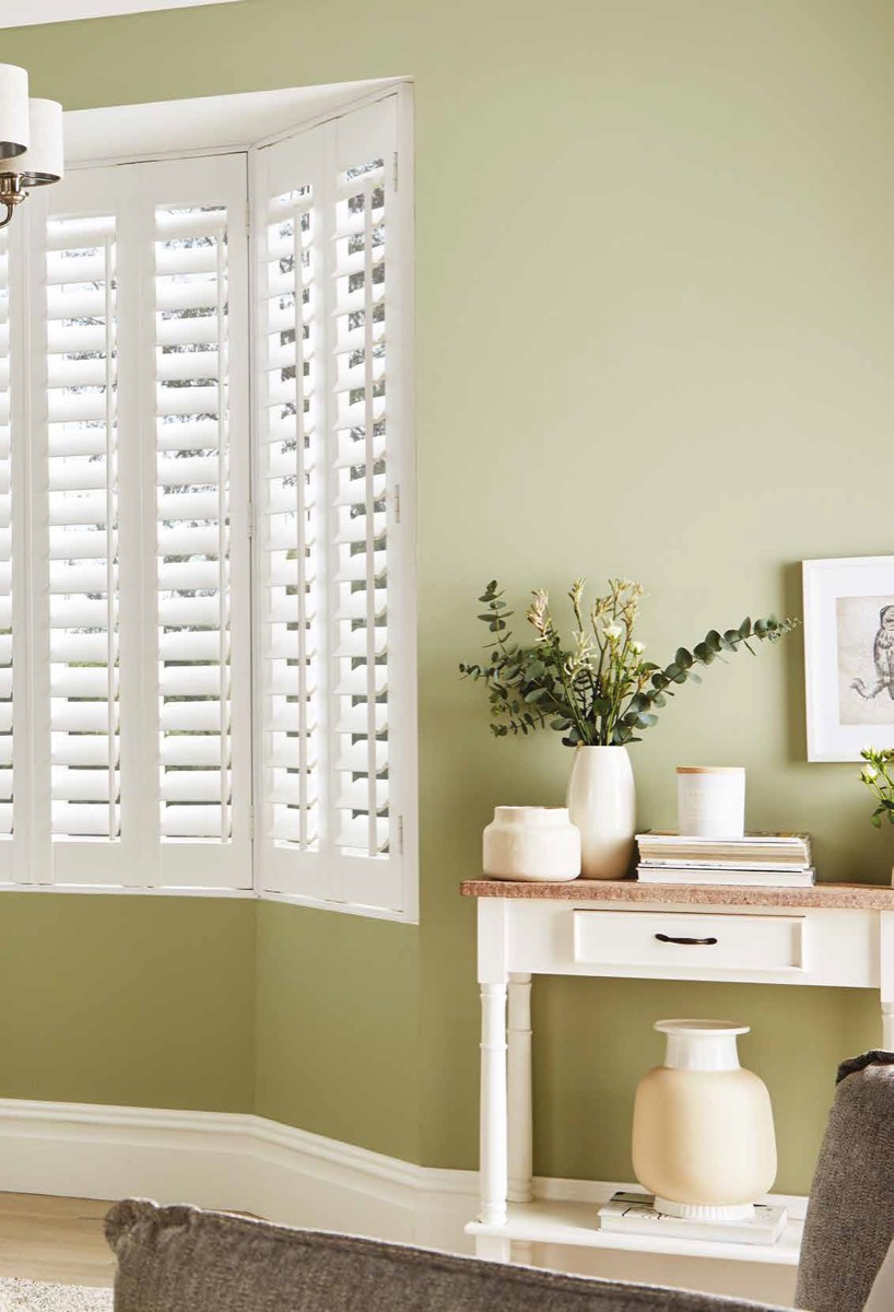 White plantation shutters in a bay window